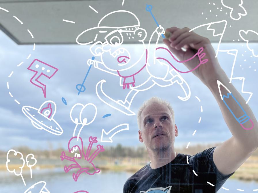 Illustrator Peter Herman tegner på vindue.